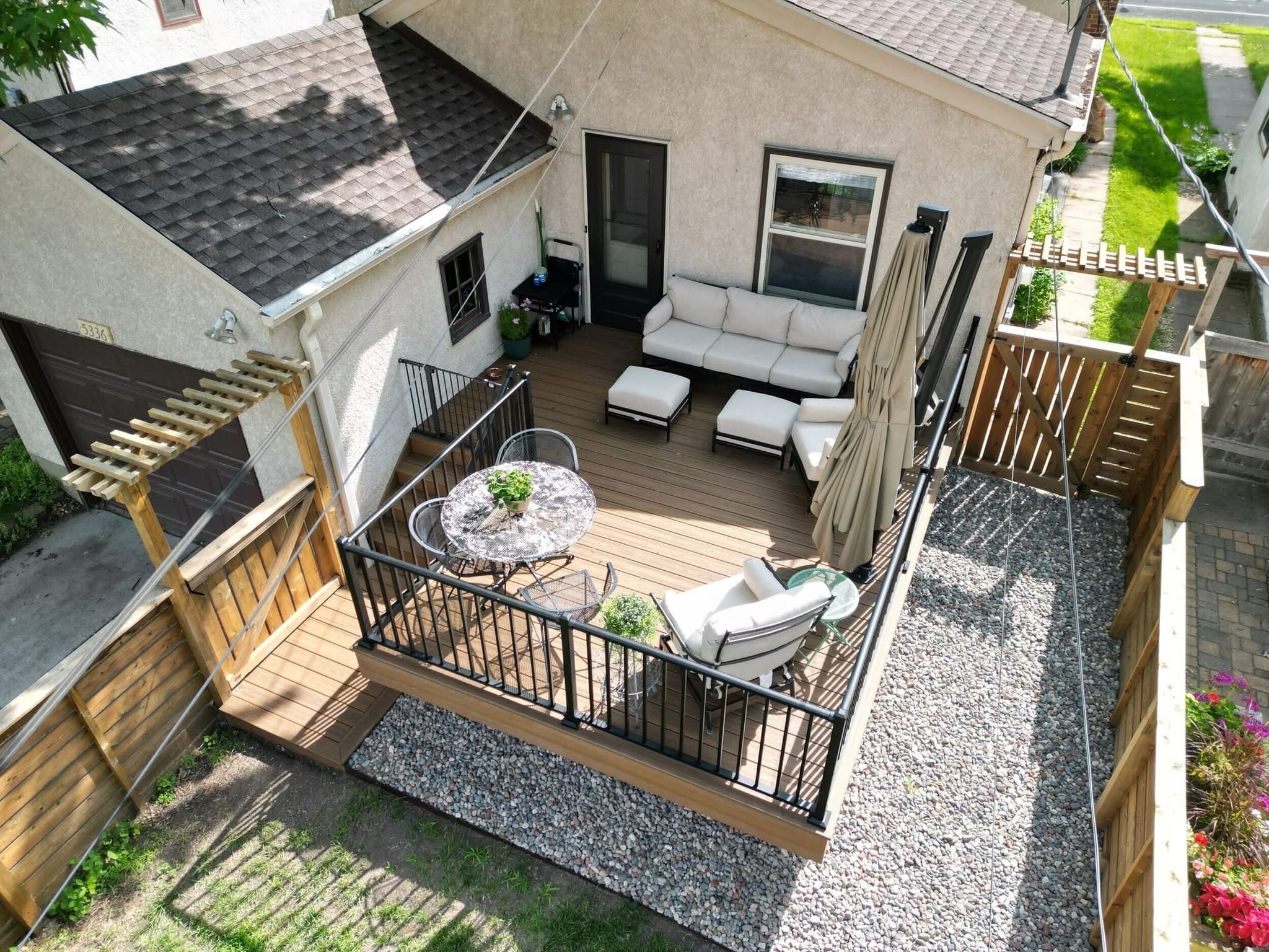 Backyard deck with a pergola over lounge furniture