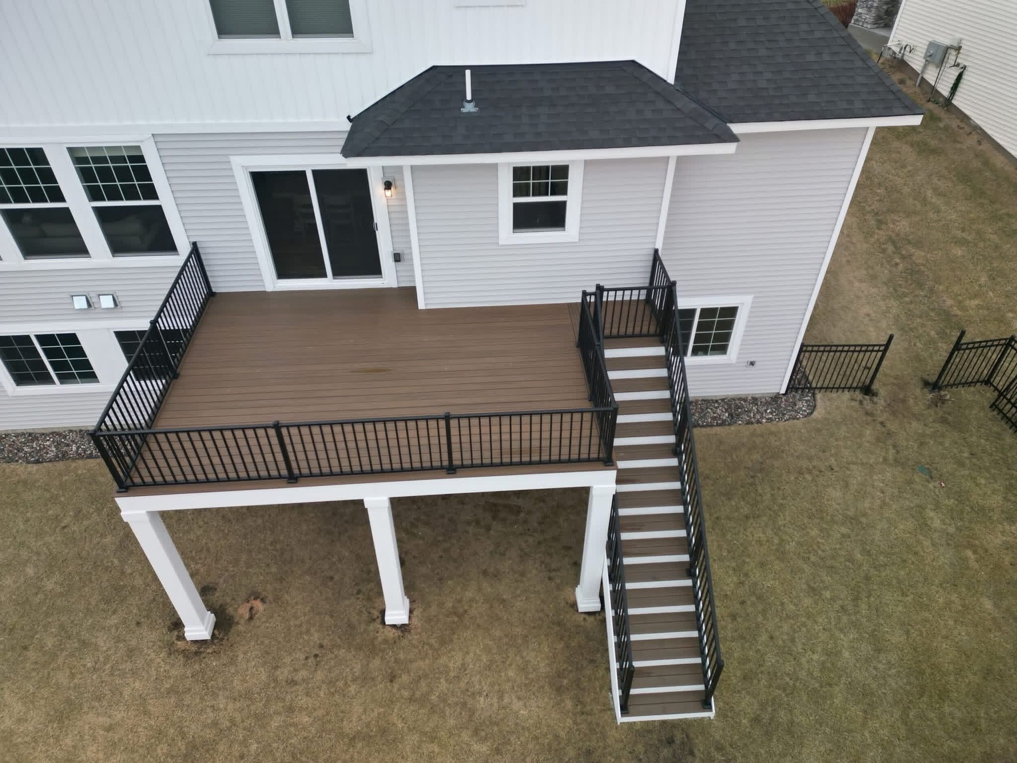 Close view of black metal deck railing on a brown composite deck