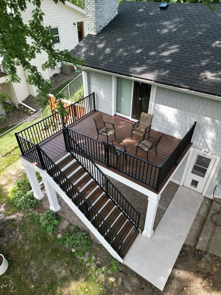 Dark capped-polymer deck with black railing and a staircase